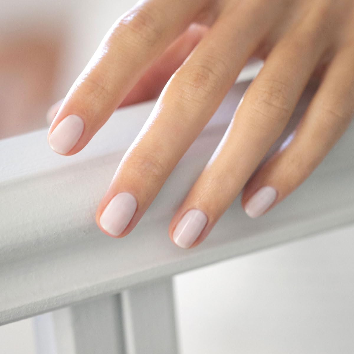 Manucurist Green Milky White swatch on nail with sheer milky coverage.