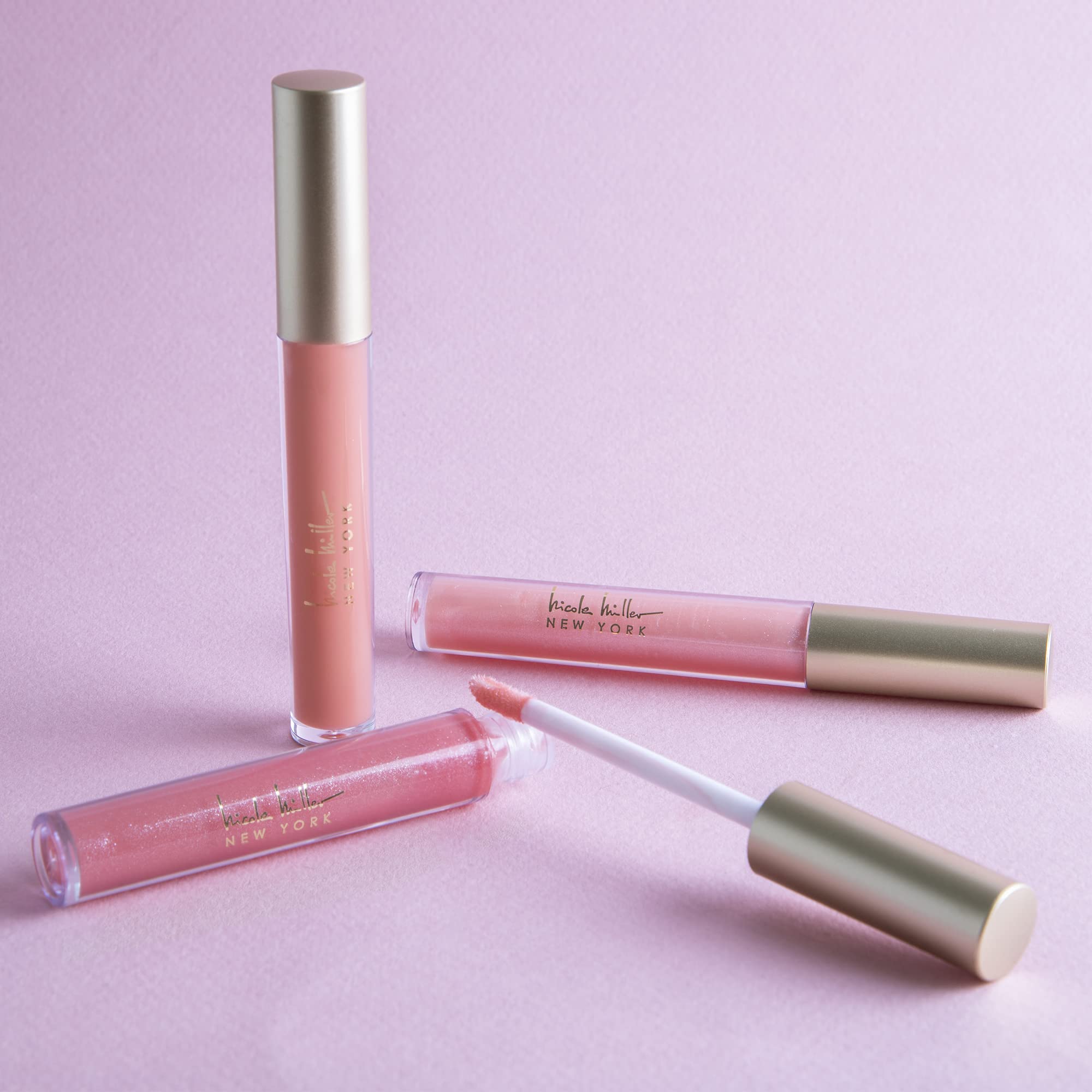 Nicole Miller lip gloss on lips with glossy, long-lasting color finish.