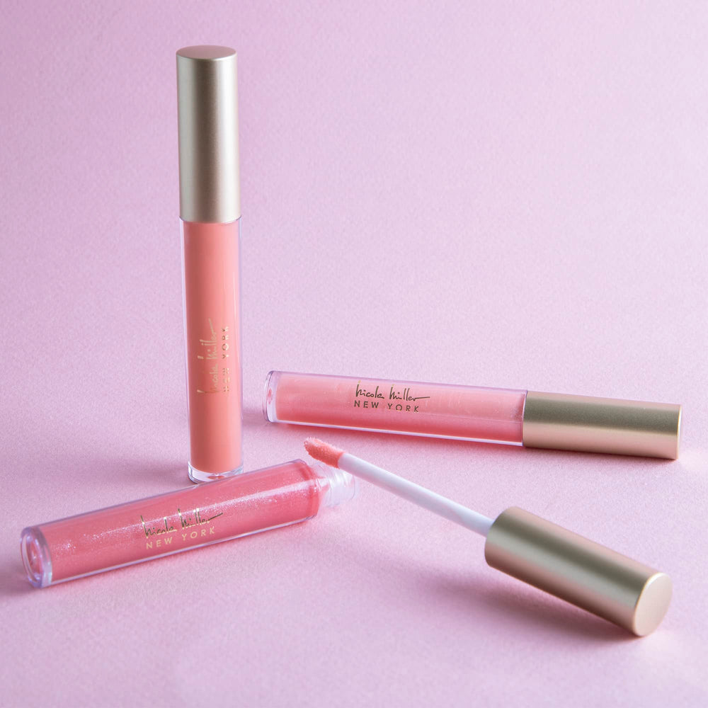 Nicole Miller lip gloss on lips with glossy, long-lasting color finish.