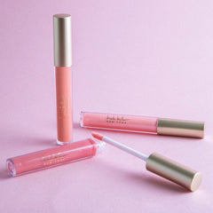 Nicole Miller lip gloss on lips with glossy, long-lasting color finish.