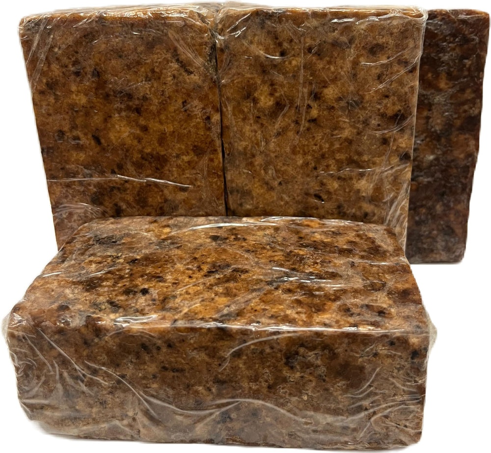Our Earth's Secrets Raw African Black Soap 1 lb packaging beside a scale for accurate weight