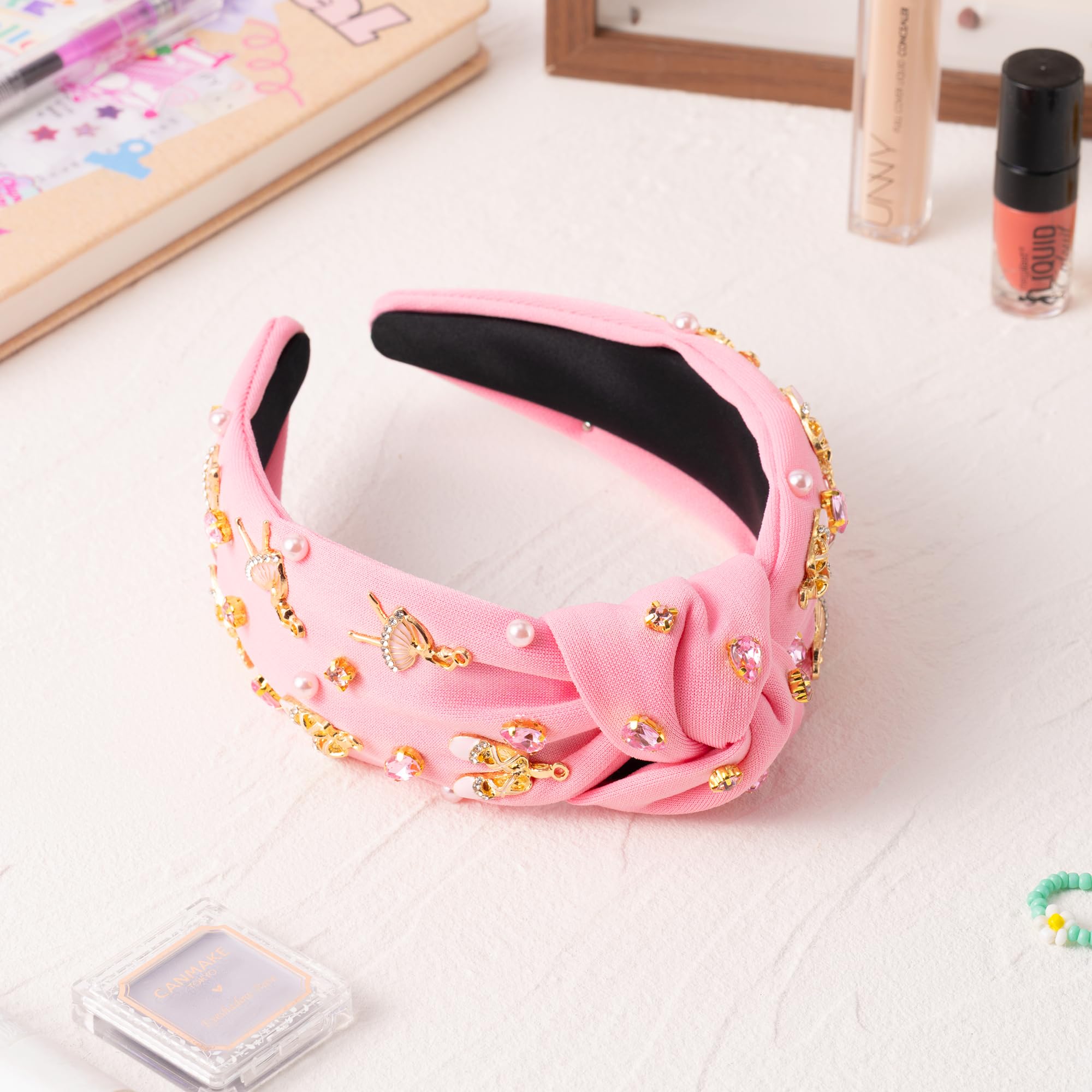 PANTIDE diadema con diseño de lazo y joyas en tono rosa.