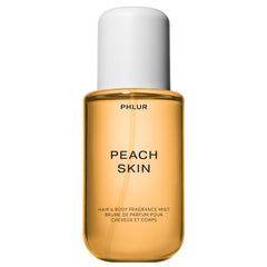 PHLUR Peach Skin Body Mist en botella elegante para uso diario suave.