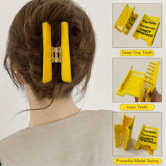 Pinza de pelo senal de precaucion para cabello fino con agarre firme.