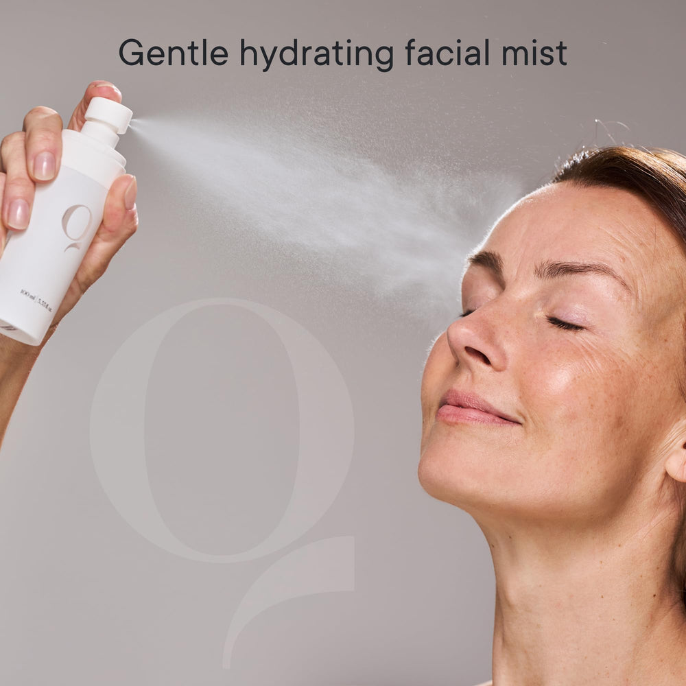 Hands holding Qure Dermal Mist bottle for on-the-go refreshment