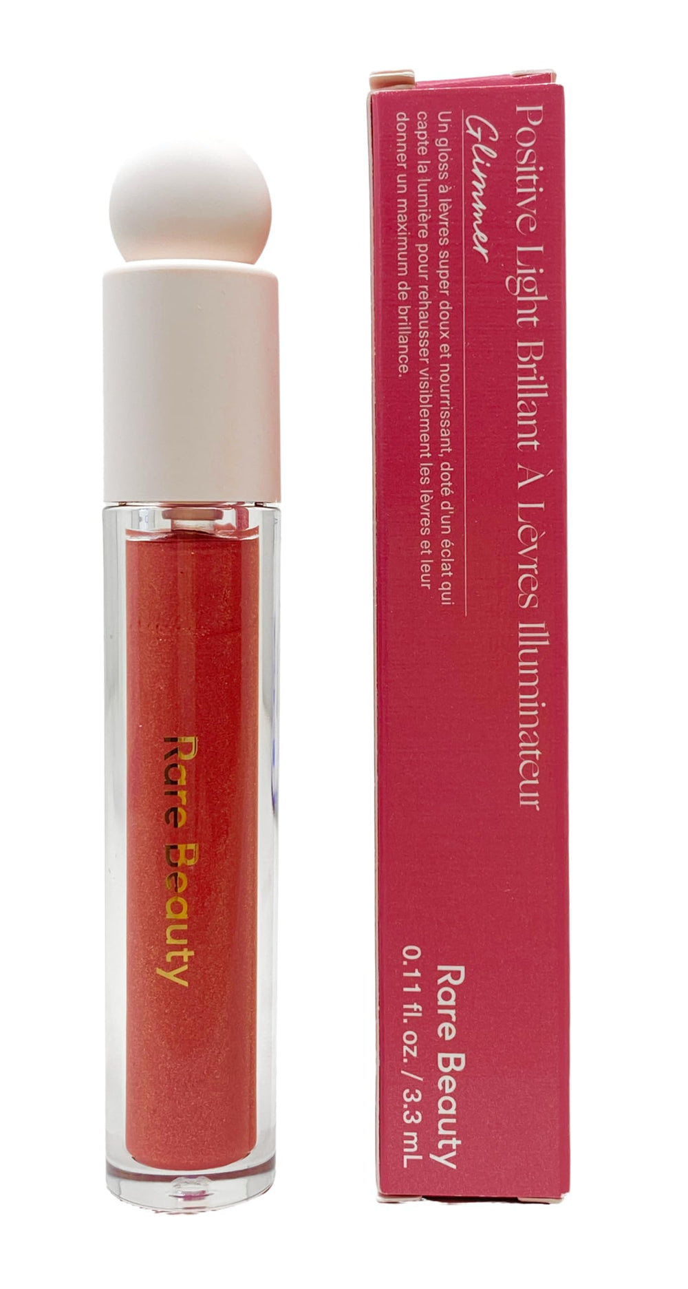 Rare Beauty brillo labial iluminante, destellos rosados y champán para un acabado radiante.