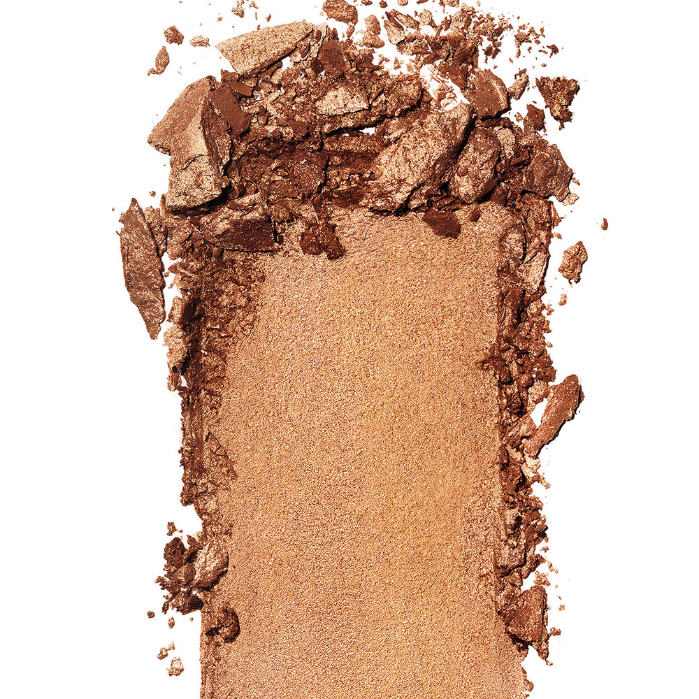 Bronceador prismático REVLON con pigmentos cristalizados para bronceado suave.