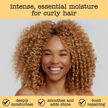 Hands applying SAUCE conditioner for smooth, detangled curls