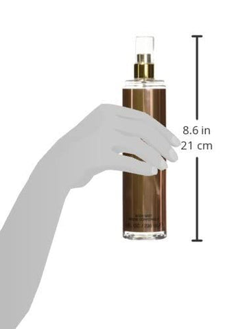 Applying Sean John Unforgivable body mist for even fragrance application.