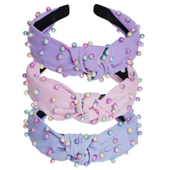 Diadema Sucrain de perlas sintéticas con nudo cruz rosa, look sofisticado.