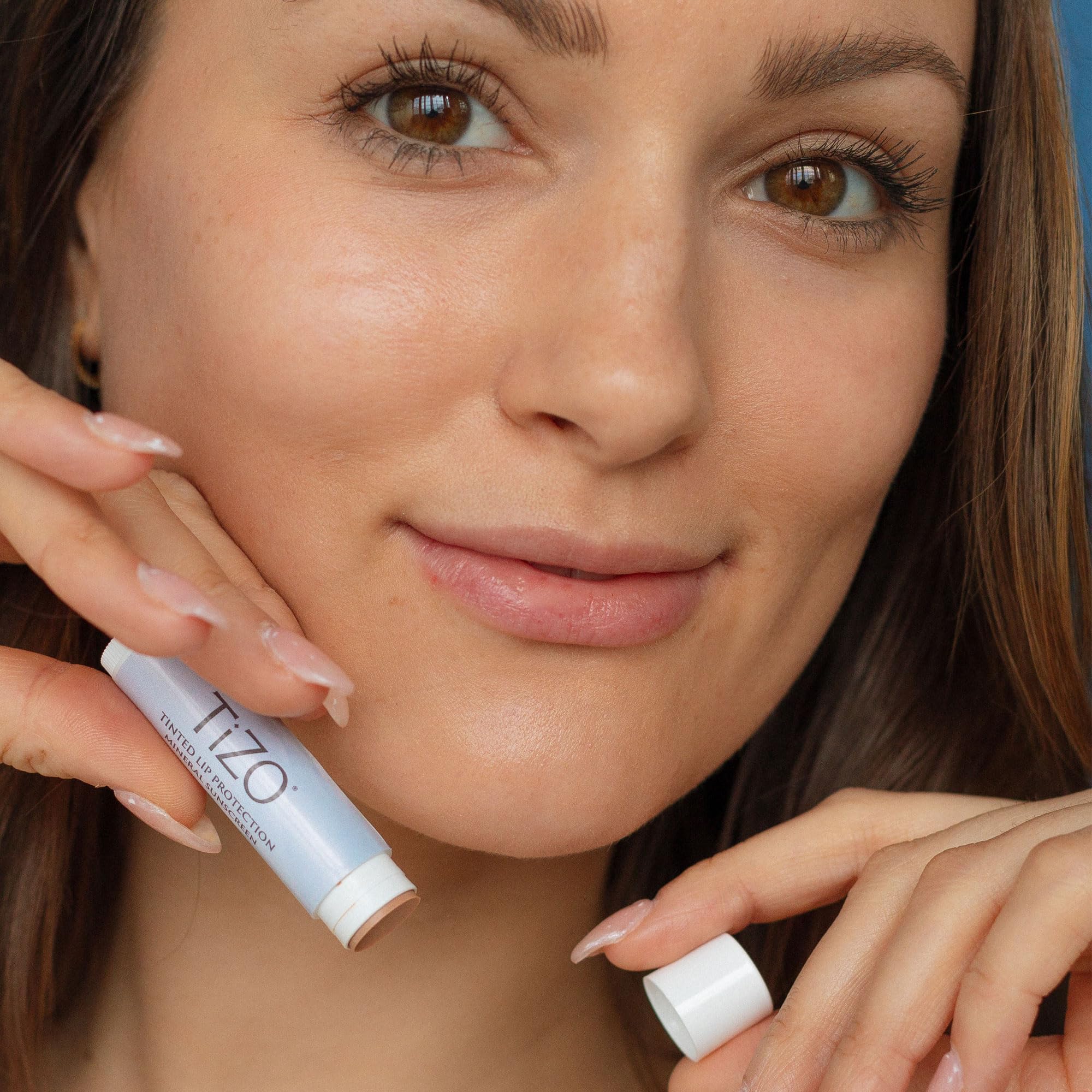 Applying TiZO Lip Protection provides mineral UV defense with smooth lip feel.