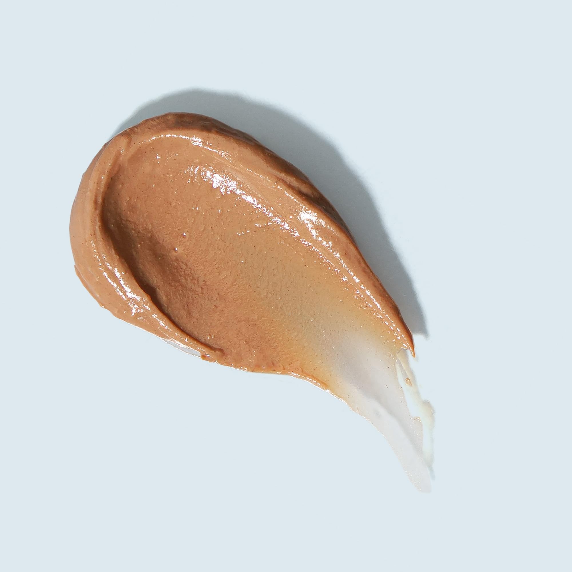 Tinted swatch on skin shows natural lip color and protection.
