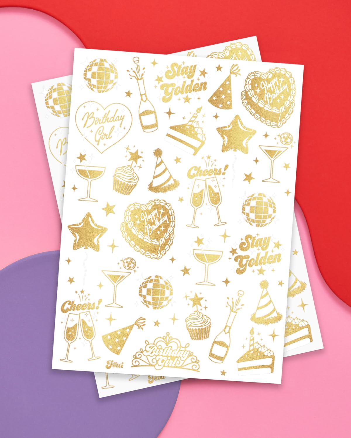 Tatuajes dorados XO Fetti con diseños de champán y pastel para celebraciones.